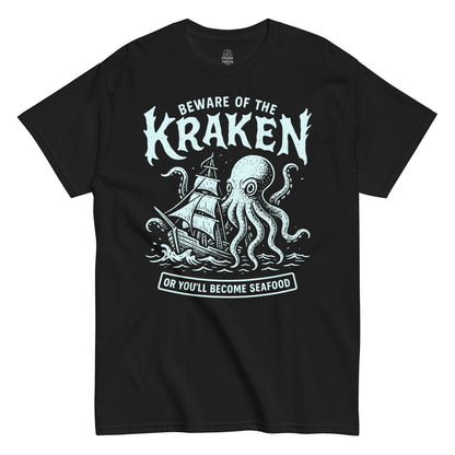 Beware of the Kraken T-shirt featuring mint-blue sea monster attacking ship with humorous “Or You’ll Become Seafood” text, printed on black fabric.
