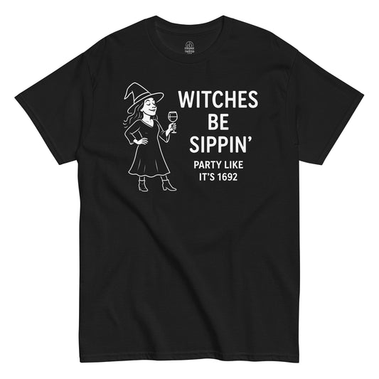 “Witches Be Sippin’ Party Like It’s 1692” design with a witch holding a wine glass on black fabric.