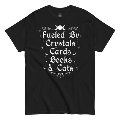 “Fueled By Crystals Cards Books & Cats” witchy text design with stars and moon symbols on black fabric.