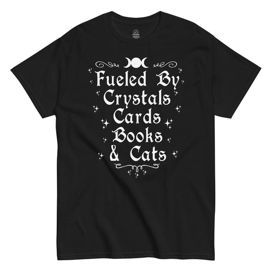 “Fueled By Crystals Cards Books & Cats” witchy text design with stars and moon symbols on black fabric.