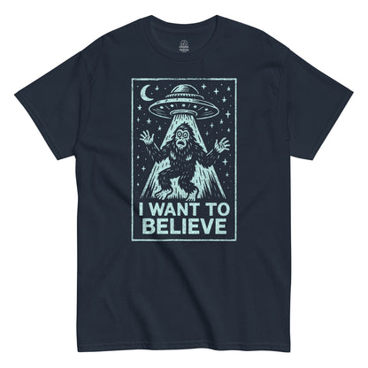 Cryptid UFO T-shirt in navy featuring Bigfoot under flying saucer with I Want To Believe text, retro alien parody design, By StrangeAndTwisted.Com