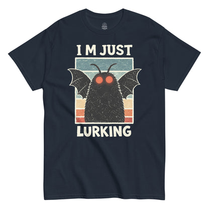 Retro Mothman silhouette with bright red eyes against a striped background, Im Just Lurking text printed on a navy t shirt