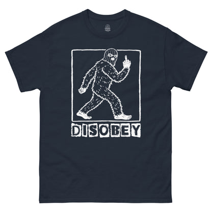 Disobey Sasquatch cryptozoology T shirt on navy blue featuring walking Bigfoot silhouette with rebellious pose