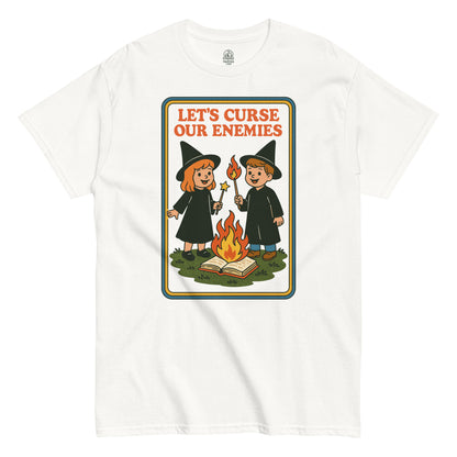 Retro witchcraft humor T-shirt with cartoon kids casting spell around fire, vintage 70s children’s book parody style, By StrangeAndTwisted.Com