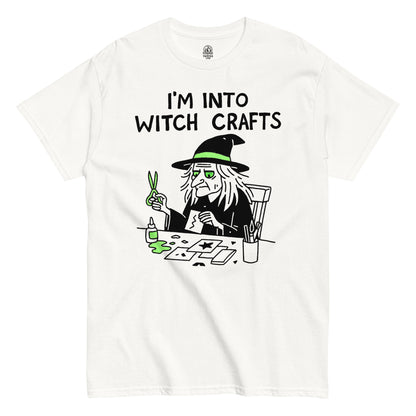 I’m Into Witch Crafts T-shirt featuring cartoon witch holding scissors over neon green potion, black outline design on white background.