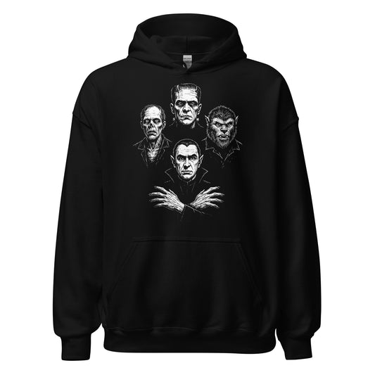 Black hoodie featuring distressed white artwork of classic horror monsters including a vampire, werewolf, zombie and stitched creature in a bold lineup, high-contrast gothic style. By Strange & Twisted.