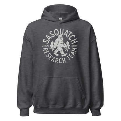 Dark heather hoodie with Sasquatch Research Team design in light grey, Bigfoot and trees inside circular badge, By Strange & Twisted