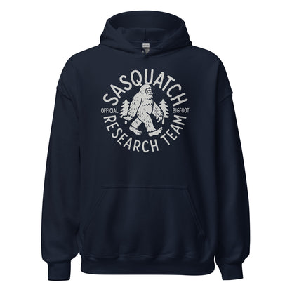 Navy hoodie with Sasquatch Research Team Bigfoot emblem in light grey, centered on chest, circular cryptid graphic, By Strange & Twisted